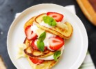 Ricotta pancakes with honey butter, strawberries and condensed milk cream